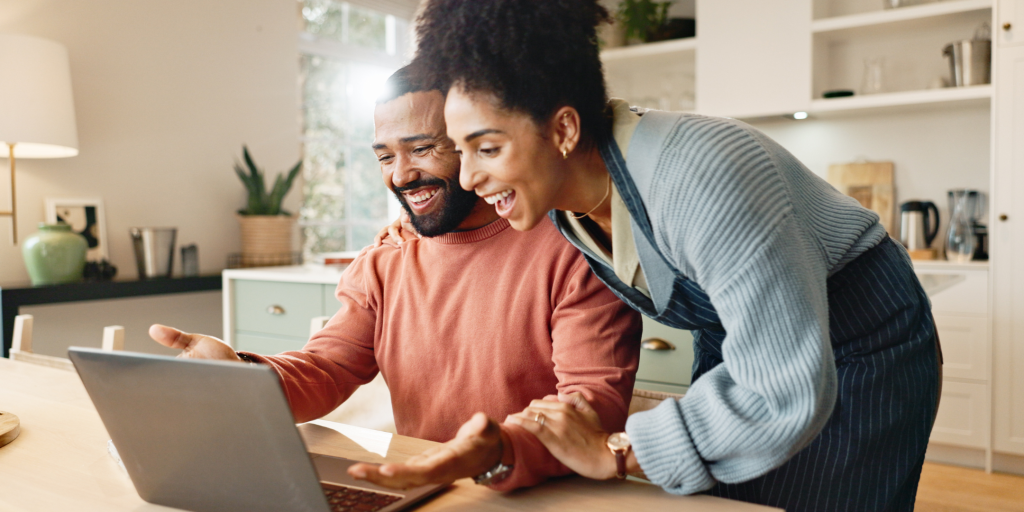 Couple look at Laptop with happy excited faces